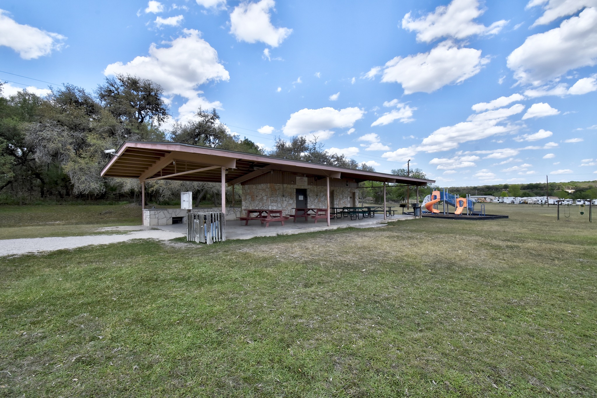 1170 Misty Lane Spring Branch, TX 78070 - Photo 22 of 24 A community recreation building with covered picnic areas next to a vibrant playground.