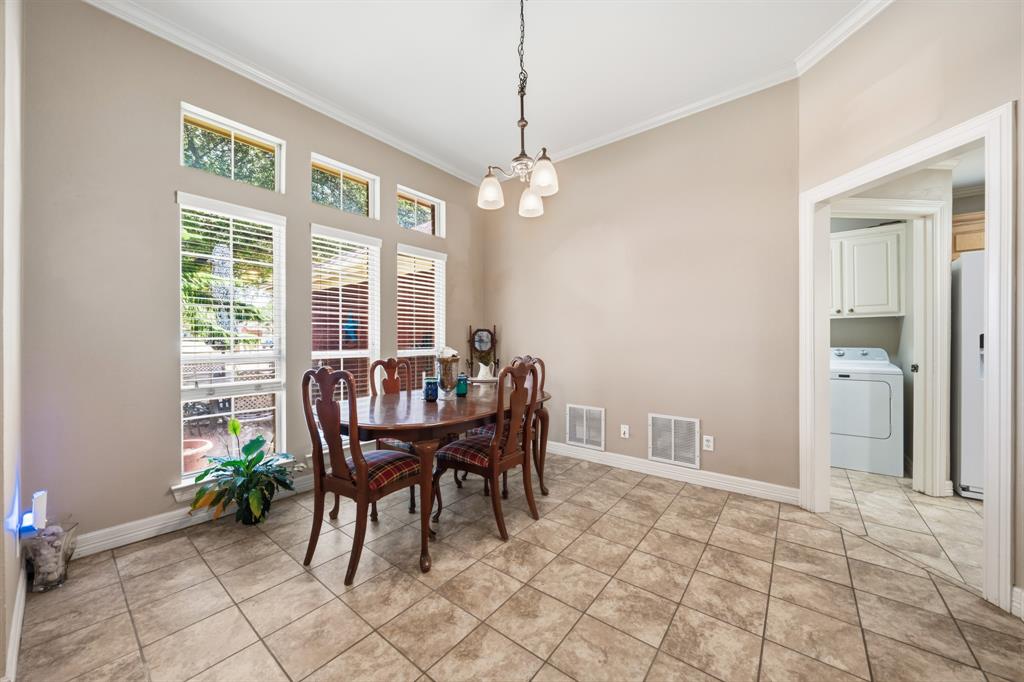 10127 Cougar Ridge Parkway Waco, TX 76708 - Photo 18 of 33 Vaulted ceiling with crown molding, tiled flooring, and a multi-pane window configuration with upper transom windows