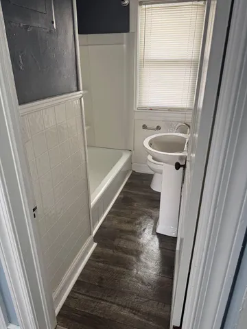 a bathroom with a bathtub and sink