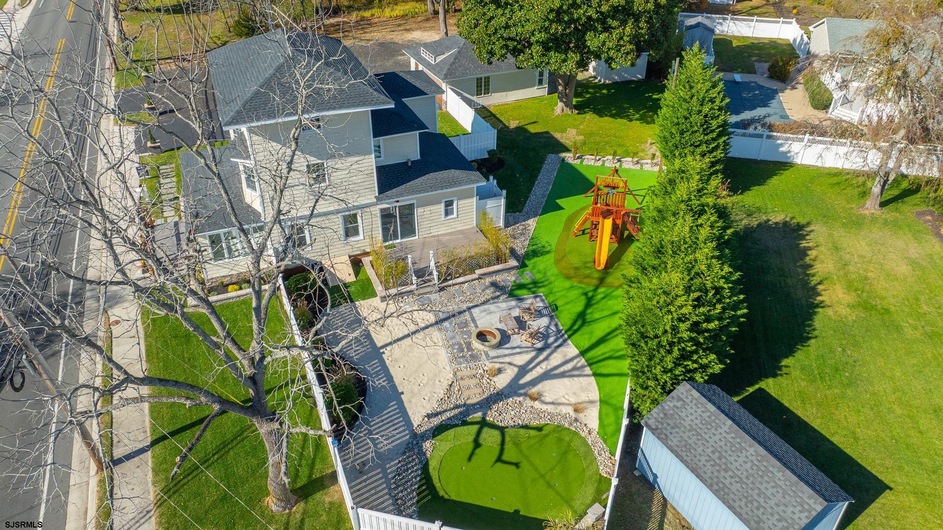 1203 West Mill Road Northfield, NJ 08225 - Photo 63 of 90 an aerial view of a house with a garden and plants