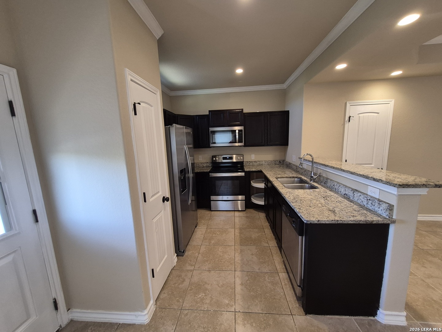 6515 Marcel Way, Unit 101 San Antonio, TX 78233 - Photo 5 of 28 a kitchen with stainless steel appliances granite countertop a refrigerator a stove and a sink