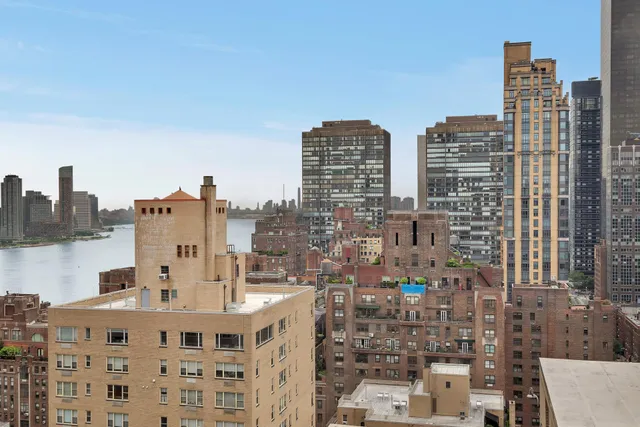 a hallway with cabinets and a wooden floor