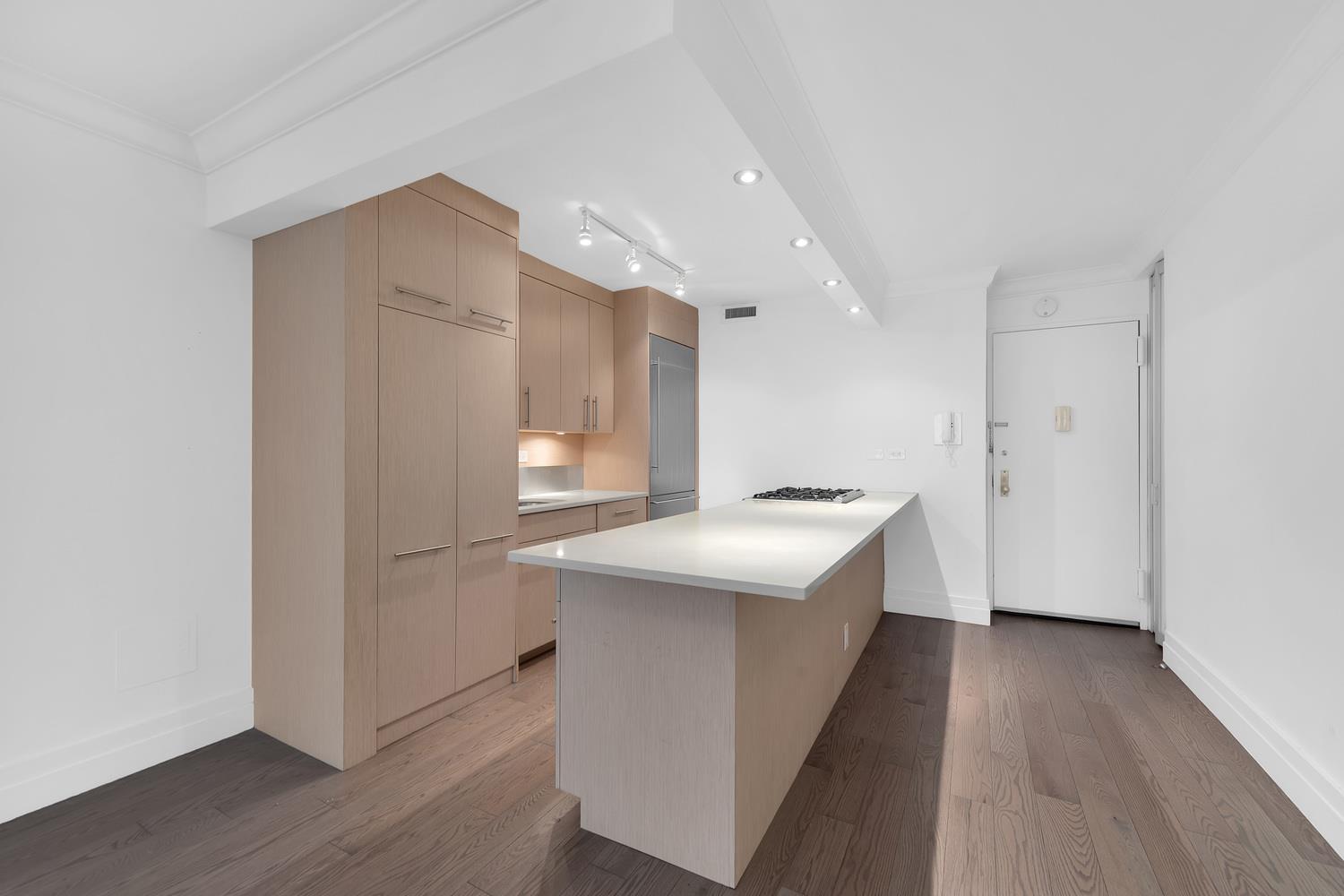 400 East 54th Street, Unit 25A Manhattan, NY 10022 - Photo 2 of 20 a kitchen with a sink stove and refrigerator