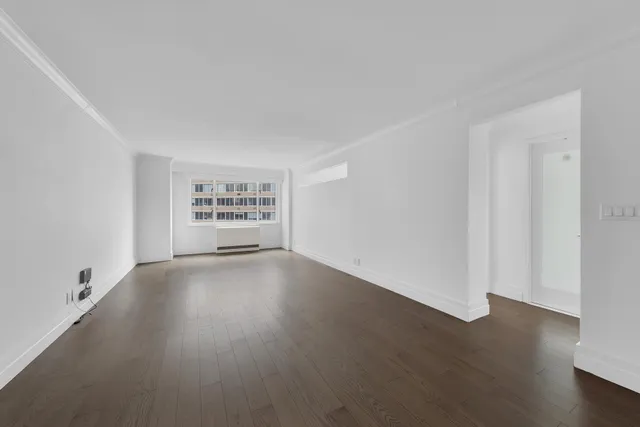 a bedroom with a bed and a potted plant