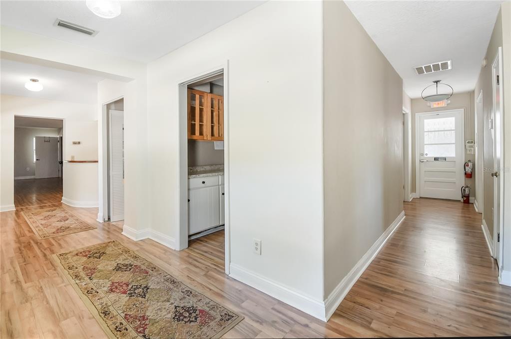 2706 Old Moultrie Road St. Augustine, FL 32086 - Photo 3 of 18 a view of a hallway with wooden floor and bedroom view