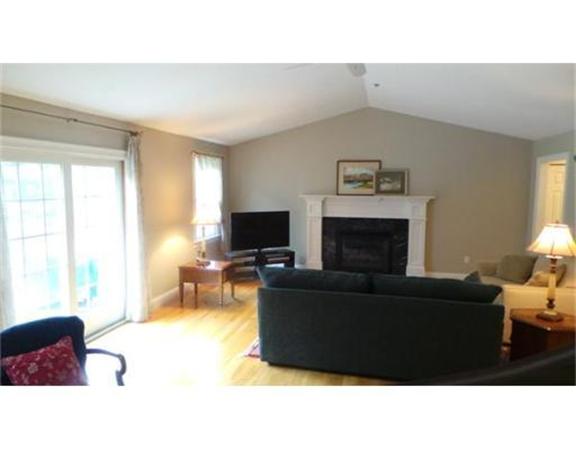 94 Mechanic Street, Unit D Foxboro, MA 02035 - Photo 11 of 30 a living room with furniture and a flat screen tv