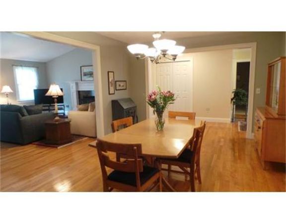 94 Mechanic Street, Unit D Foxboro, MA 02035 - Photo 13 of 30 a dining room with furniture a chandelier and wooden floor