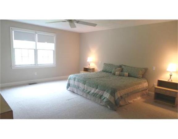 94 Mechanic Street, Unit D Foxboro, MA 02035 - Photo 20 of 30 a living room with a bed furniture and a window