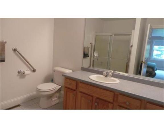 94 Mechanic Street, Unit D Foxboro, MA 02035 - Photo 22 of 30 a bathroom with a sink toilet a mirror and shower