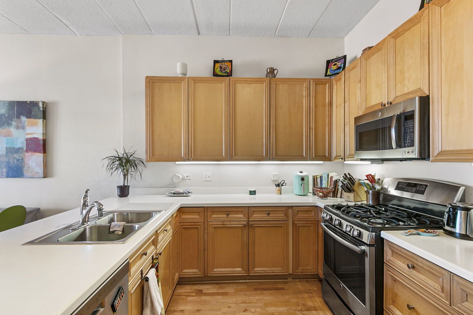 1301 West Washington Boulevard, Unit 508 Chicago, IL 60607 - Photo 4 of 17 a kitchen with stainless steel appliances a sink a stove cabinets and a sink