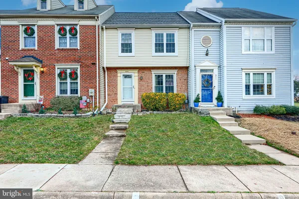front view of a brick house with a yard