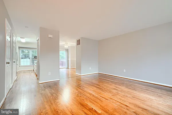 a view of an empty room and wooden floor
