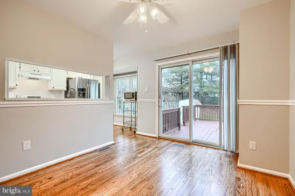 a view of a room with wooden floor and furniture