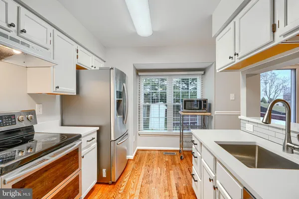 a kitchen with stainless steel appliances granite countertop a stove and a sink