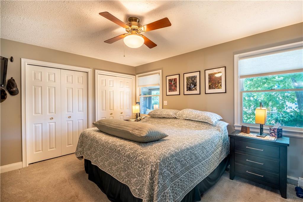 228 Country View Drive Lower Burrell, PA 15068 - Photo 17 of 49 a bedroom with a large bed and a chandelier