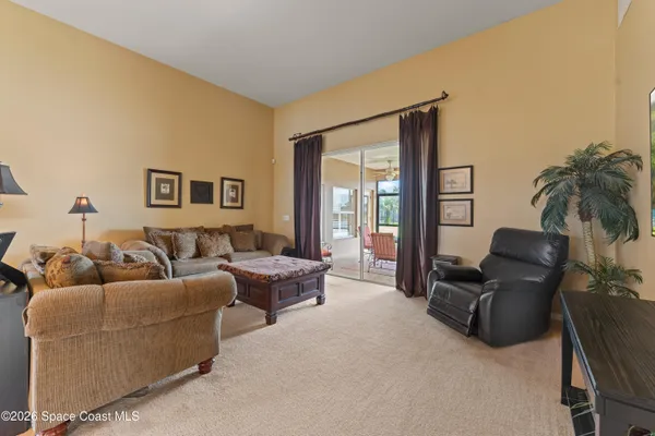 a bedroom with furniture and a large window
