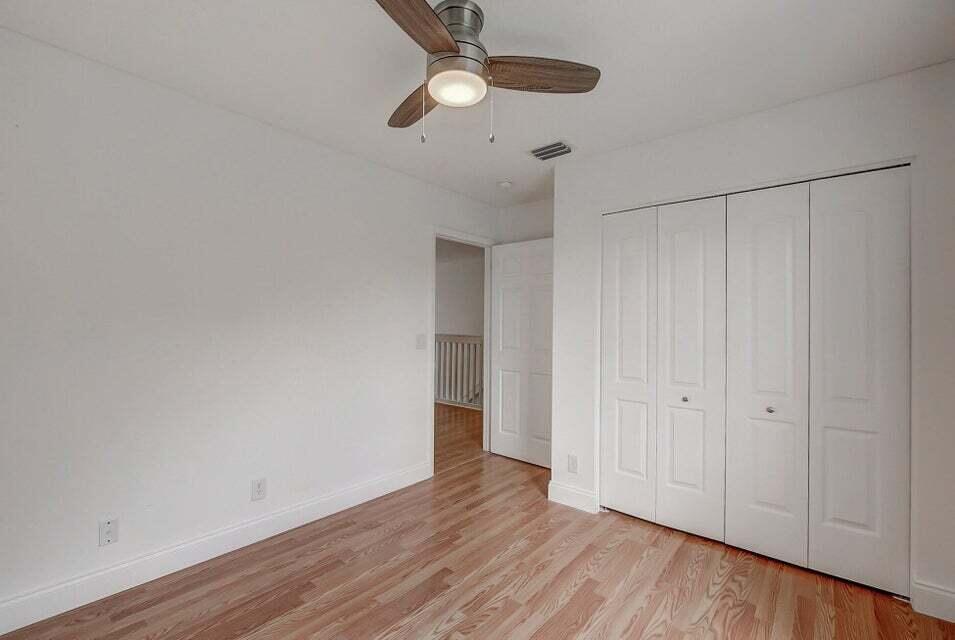 10758 Lake Jasmine Drive Boca Raton, FL 33498 - Photo 13 of 34 a view of an empty room with wooden floor