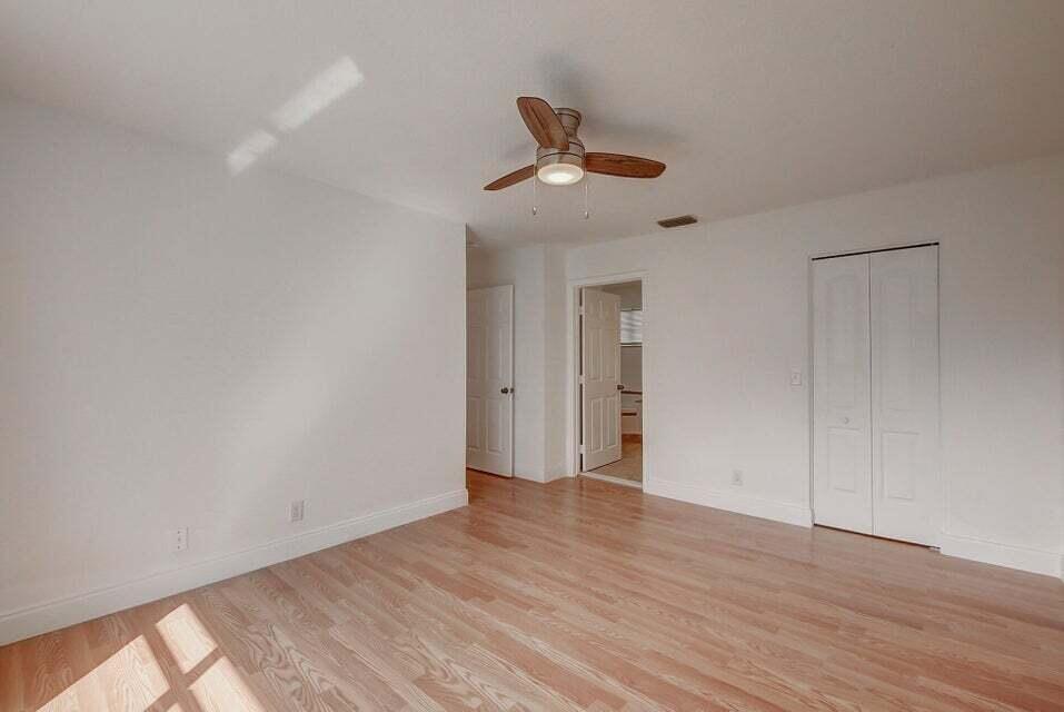 10758 Lake Jasmine Drive Boca Raton, FL 33498 - Photo 17 of 34 a view of an empty room and wooden floor