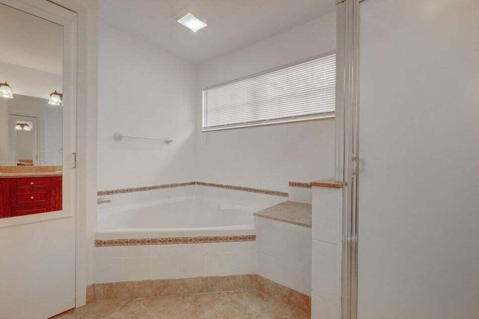 10758 Lake Jasmine Drive Boca Raton, FL 33498 - Photo 20 of 34 a bathroom with a bathtub