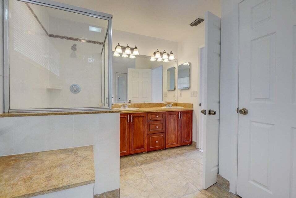 10758 Lake Jasmine Drive Boca Raton, FL 33498 - Photo 21 of 34 a bathroom with a granite countertop sink mirror and a