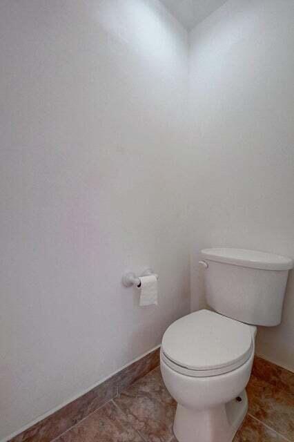 10758 Lake Jasmine Drive Boca Raton, FL 33498 - Photo 22 of 34 a white toilet sitting next to a white sink