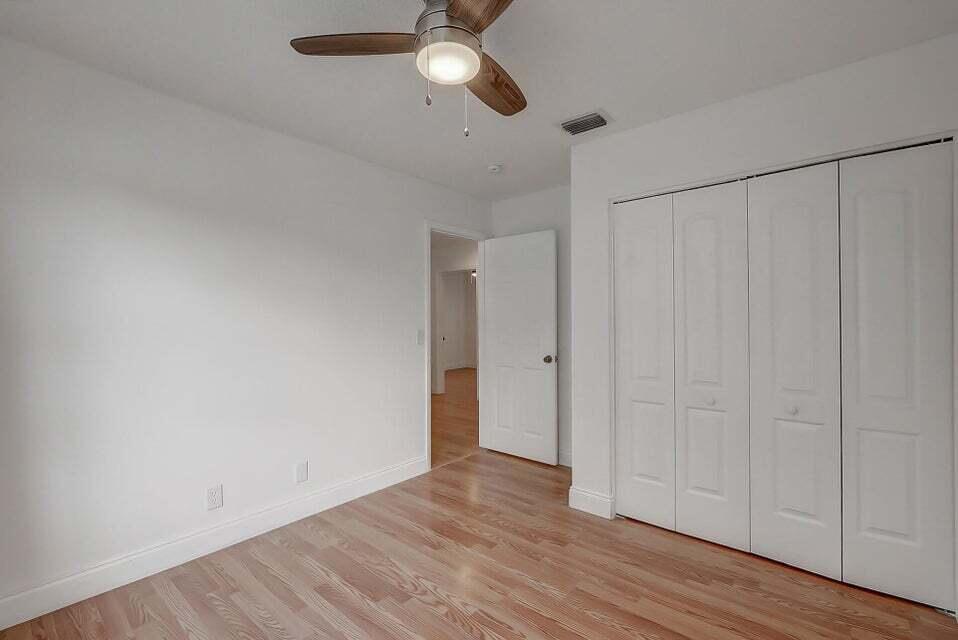 10758 Lake Jasmine Drive Boca Raton, FL 33498 - Photo 25 of 34 a view of an empty room and wooden floor
