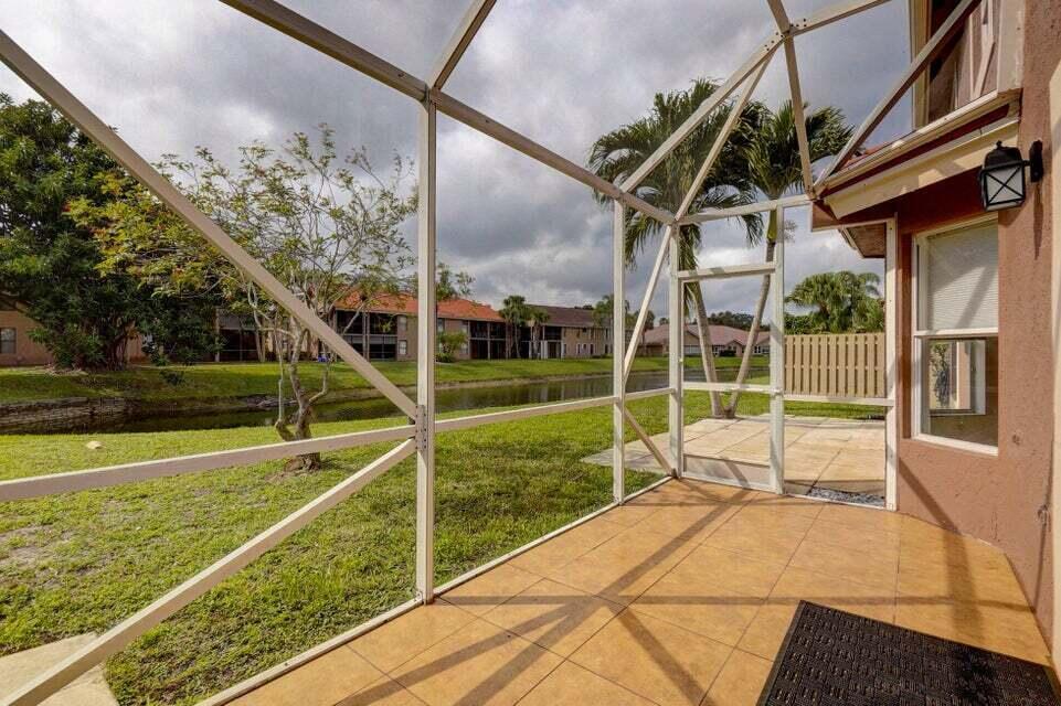 10758 Lake Jasmine Drive Boca Raton, FL 33498 - Photo 26 of 34 a view of a house with a swimming pool