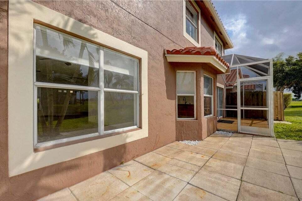 10758 Lake Jasmine Drive Boca Raton, FL 33498 - Photo 28 of 34 a view of a house with a large window
