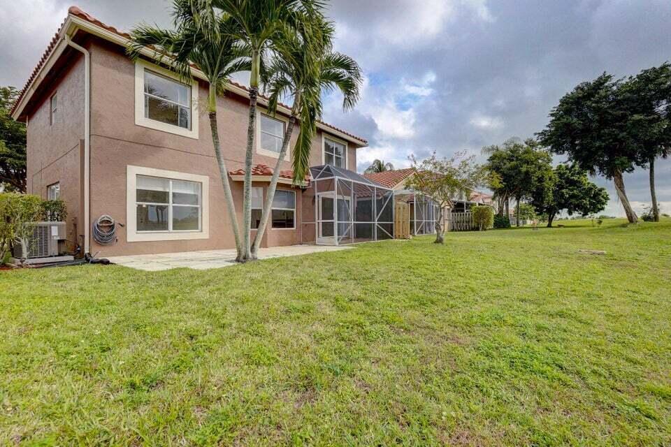 10758 Lake Jasmine Drive Boca Raton, FL 33498 - Photo 33 of 34 front view of a house with a yard