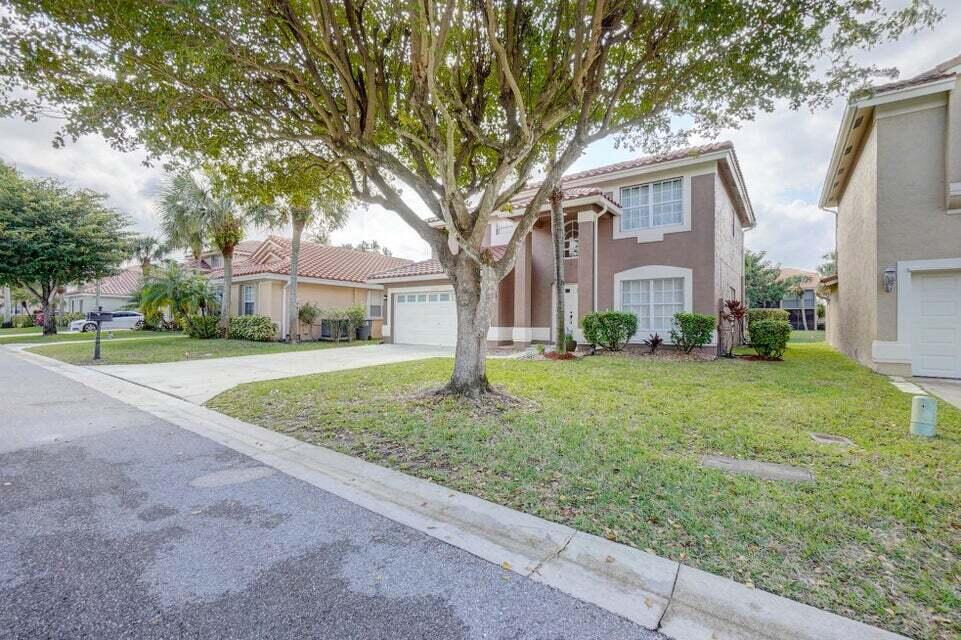 10758 Lake Jasmine Drive Boca Raton, FL 33498 - Photo 34 of 34 a front view of a house with garden
