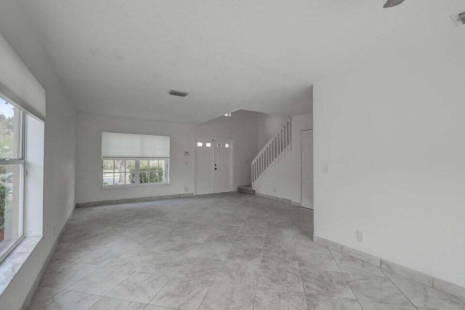 10758 Lake Jasmine Drive Boca Raton, FL 33498 - Photo 9 of 34 an empty room with windows