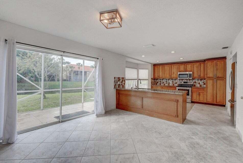10758 Lake Jasmine Drive Boca Raton, FL 33498 - Photo 10 of 34 a view of kitchen with kitchen island and windows