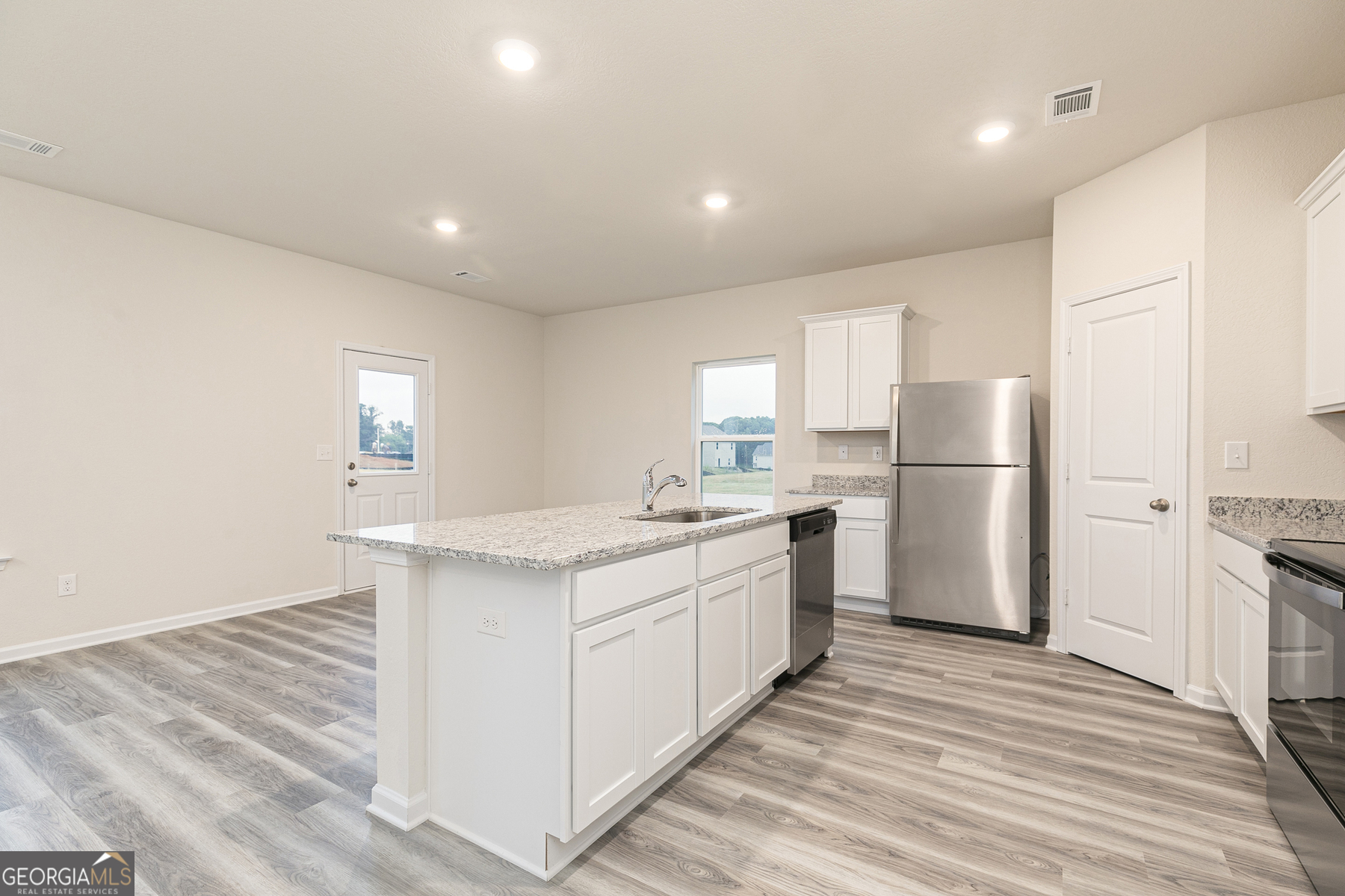 628 Slate Road Conyers, GA 30013 - Photo 9 of 25 a kitchen with white cabinets and white appliances