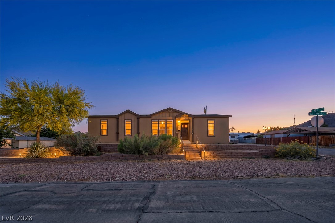 225 California Street Searchlight, NV 89046 - Photo 1 of 64 Illuminated entry welcomes you to this charming residence, framed by mature desert landscaping.
