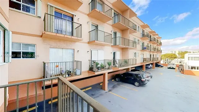 a view of a building with cars