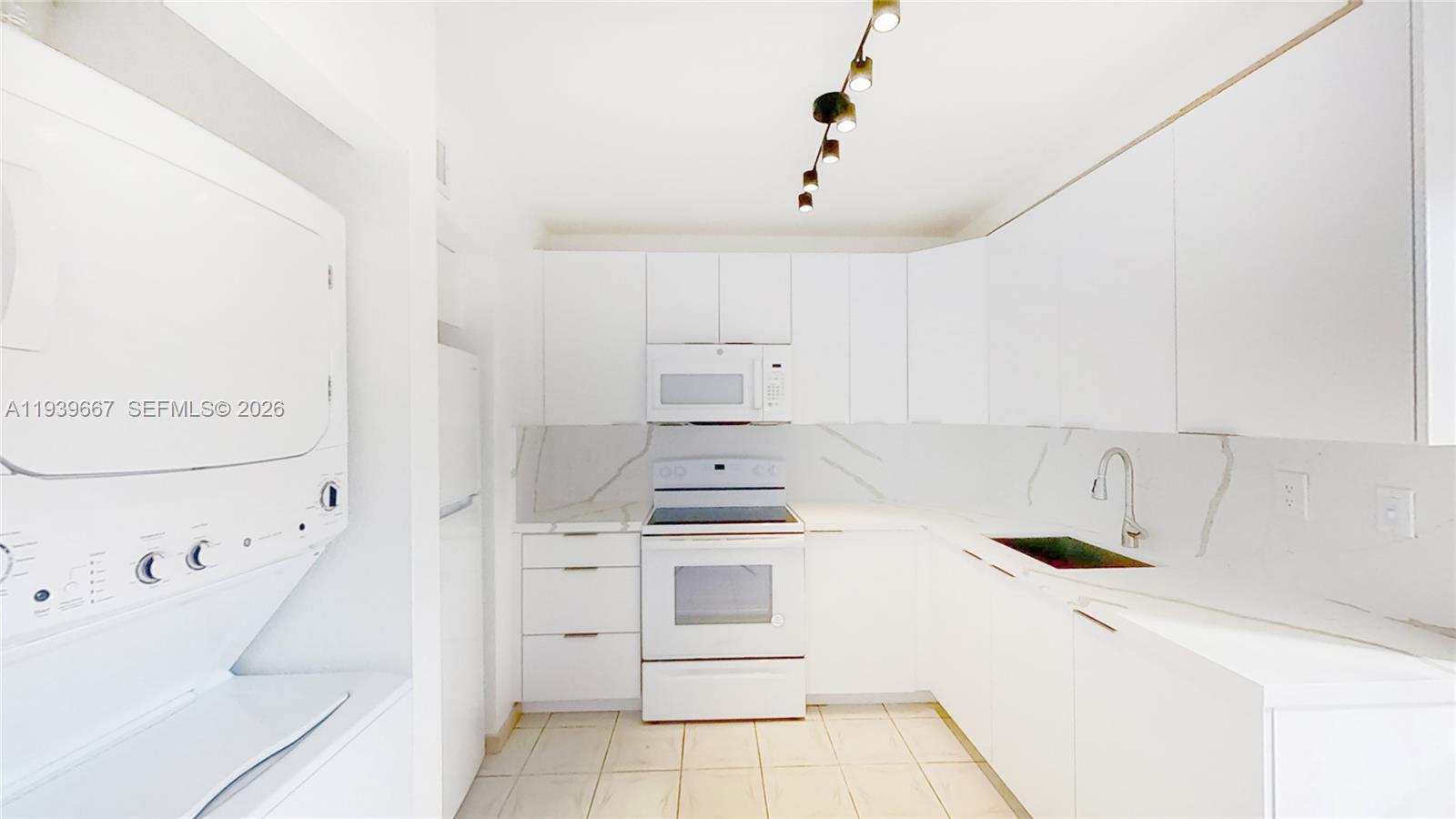 199 Southwest 12th Avenue, Unit 313E Miami, FL 33130 - Photo 2 of 21 a kitchen with white cabinets and white appliances