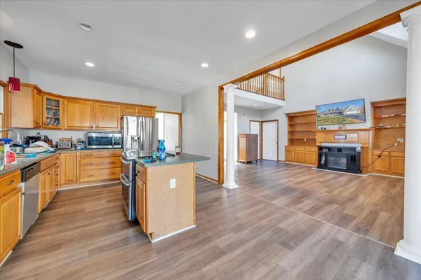 a large kitchen with stainless steel appliances granite countertop a large counter top a stove and a refrigerator