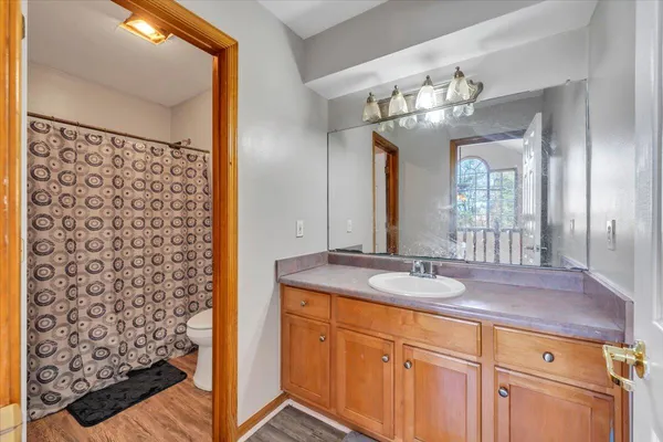 a bathroom with a granite countertop sink a large mirror and a shower