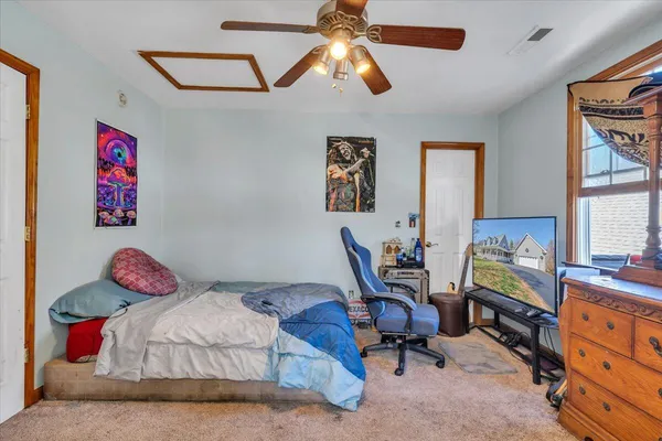 a bedroom with a bed and a chandelier