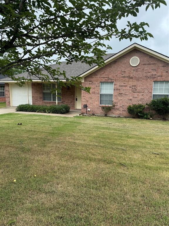 1109 North Riggins Street Anna, TX 75409 - Photo 10 of 11 a view of a yard in front of a house with a large tree