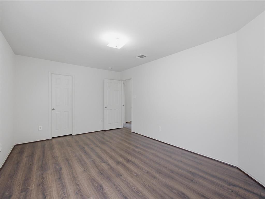 2021 Laughlin Road Fort Worth, TX 76177 - Photo 30 of 40 a view of an empty room with wooden floor