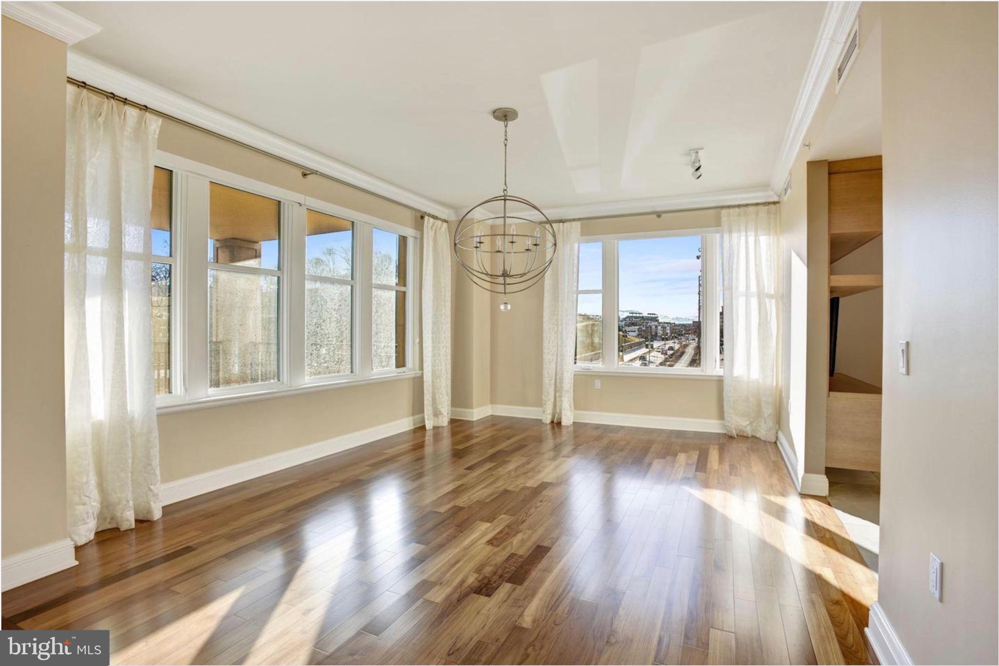 801 Key Highway, Unit 413 Baltimore, MD 21230 - Photo 12 of 40 a view of an entryway with wooden floor and windows
