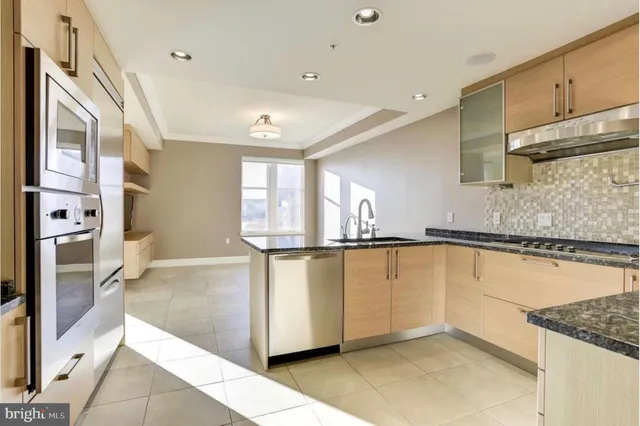 a view of a kitchen with wooden floor and a fireplace