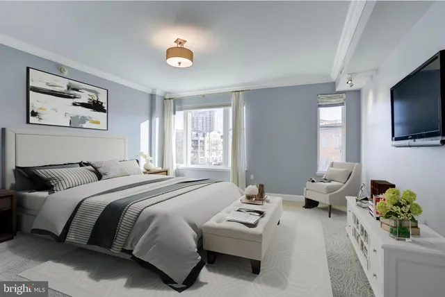 a bedroom with a bed couch and a window