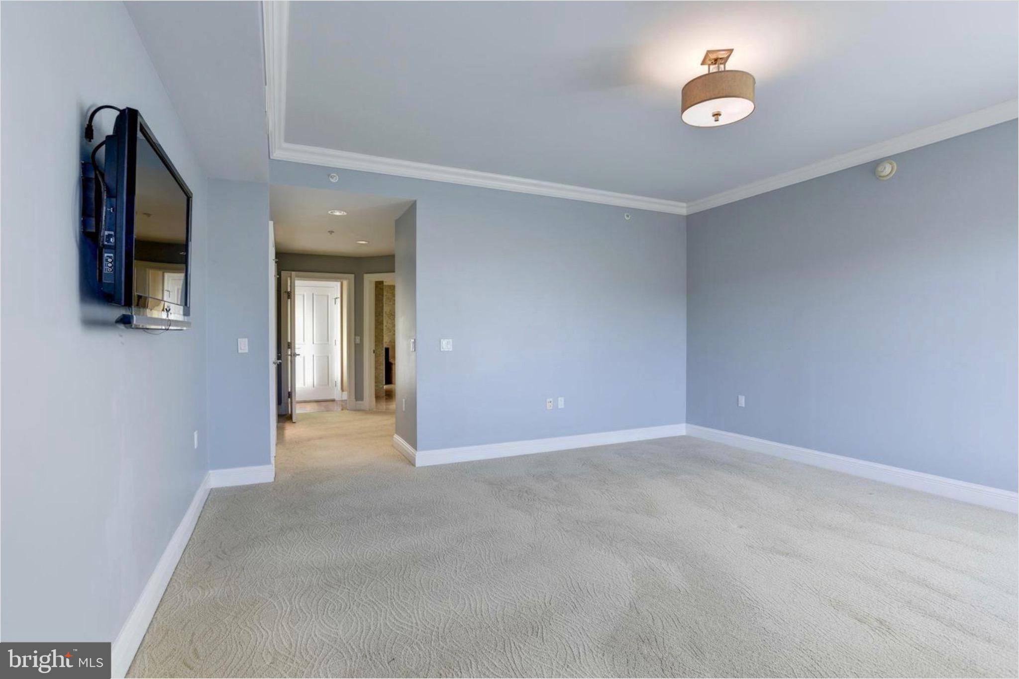 801 Key Highway, Unit 413 Baltimore, MD 21230 - Photo 24 of 40 an empty room with windows and fireplace