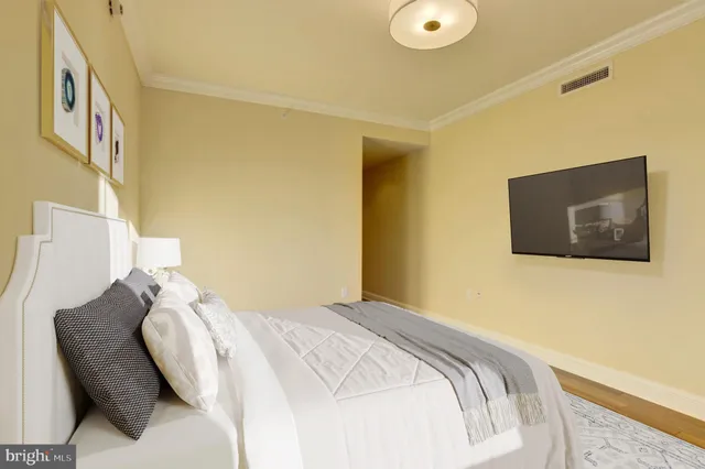 a bedroom with a bed and a painting on the wall