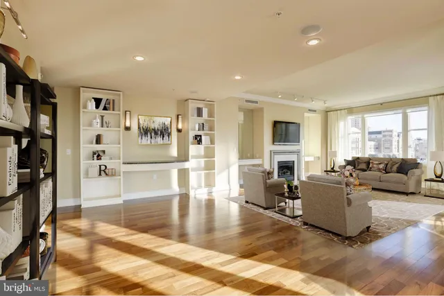 a living room with furniture window and a flat screen tv