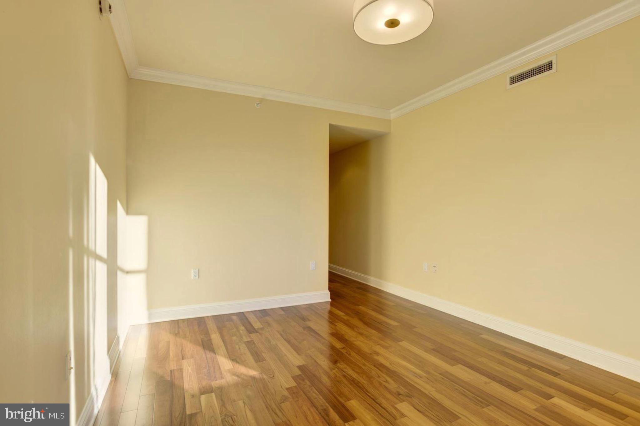 801 Key Highway, Unit 413 Baltimore, MD 21230 - Photo 31 of 40 a view of an empty room with wooden floor and a window