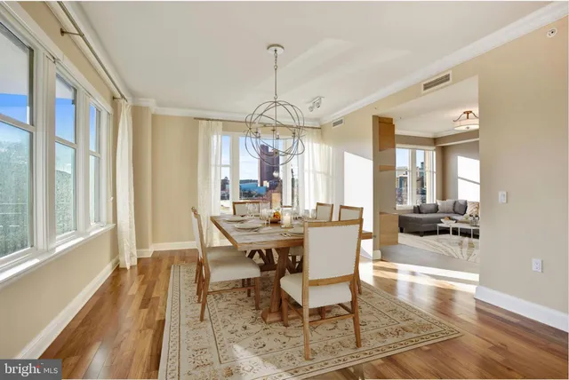 a view of a a dining room with furniture window and wooden floor