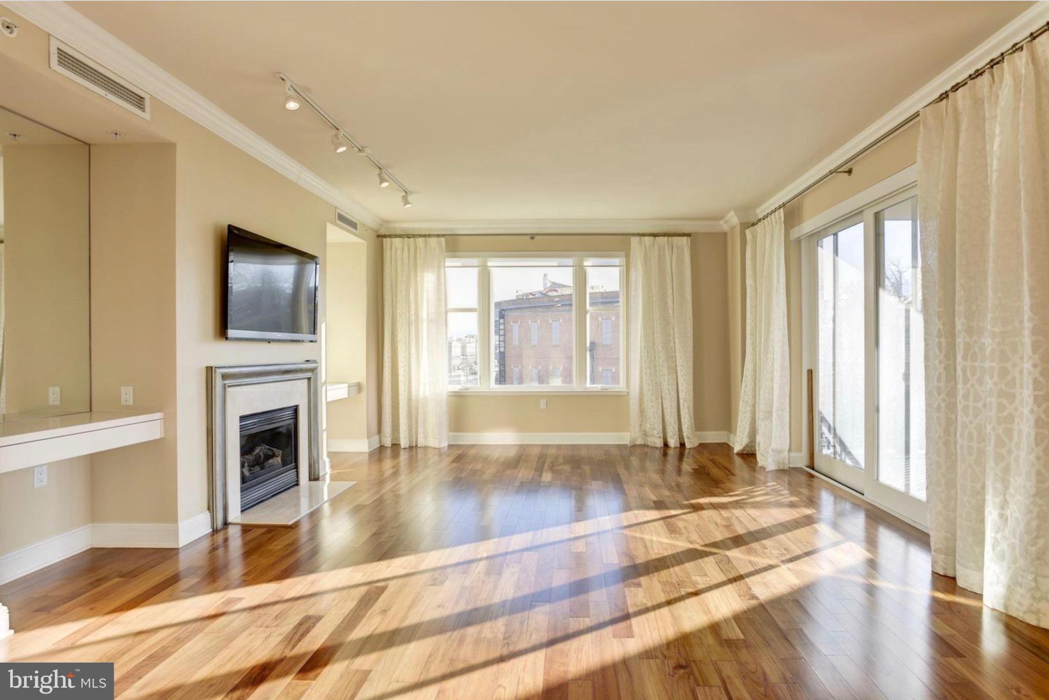 801 Key Highway, Unit 413 Baltimore, MD 21230 - Photo 8 of 40 a view of an empty room with wooden floor and a window